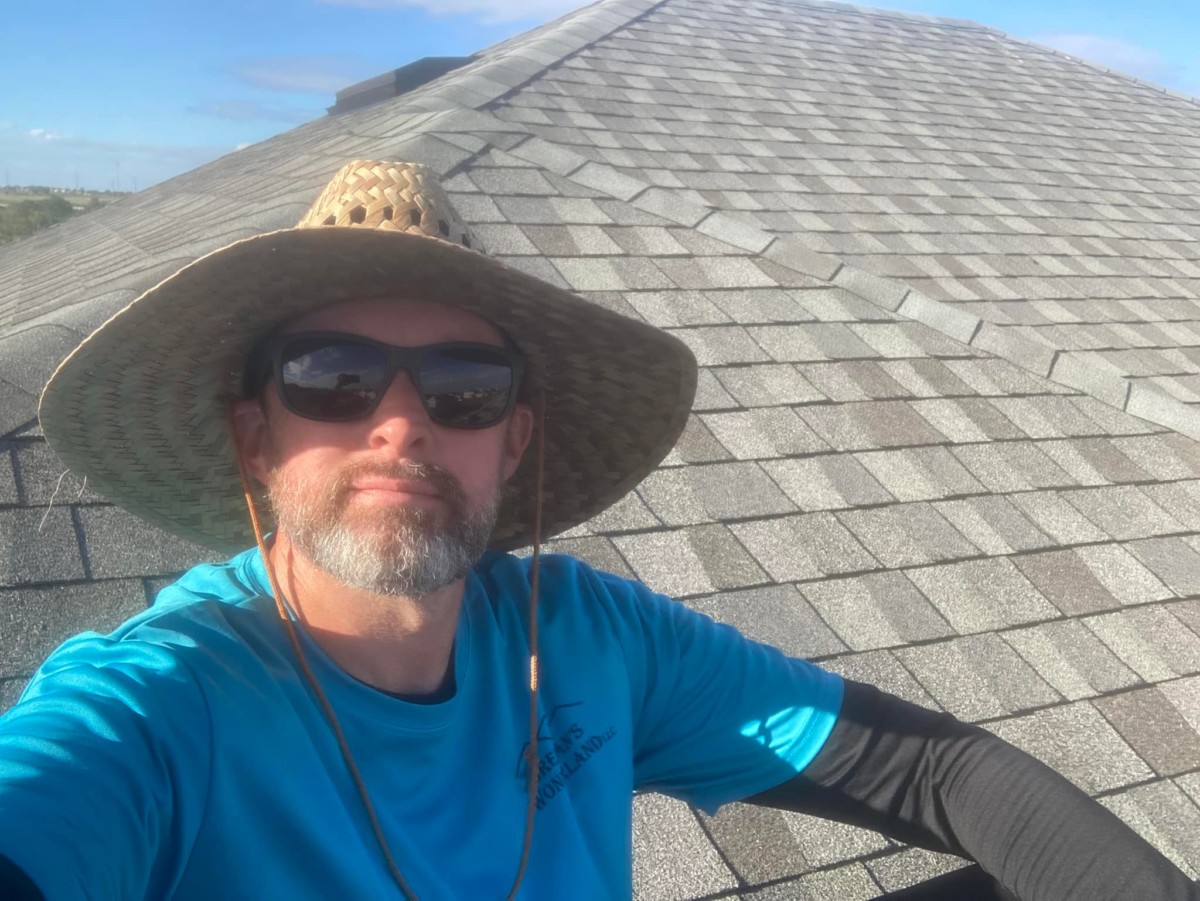 Owner of Brennan's Wonderland working on a residential roof